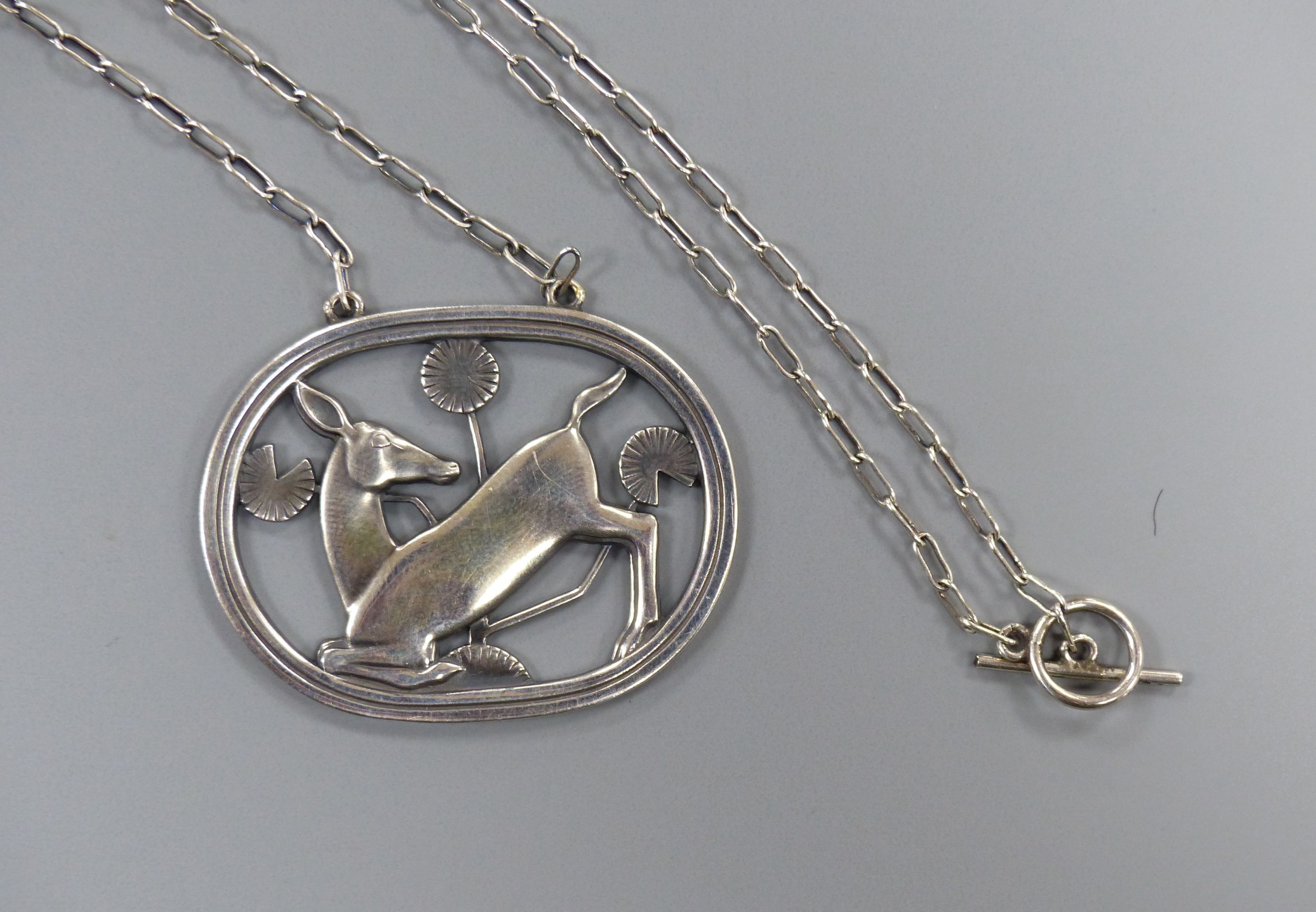 A Georg Jensen sterling oval kneeling deer pendant necklace, no. 95, pendant 42mm, chain, 58cm.